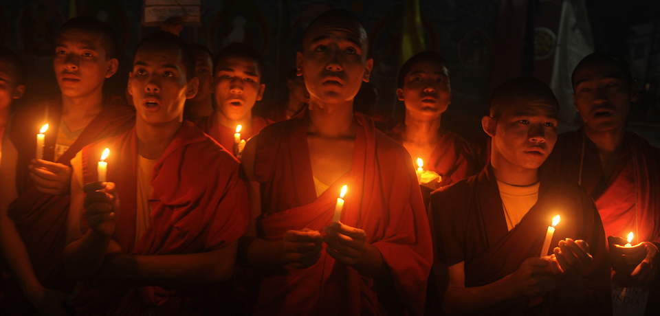 a group of people holding candles in their hands