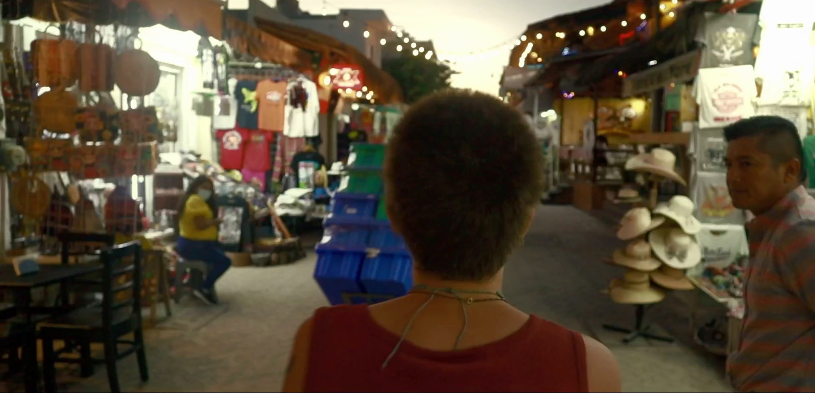 a man and a woman walking through a market