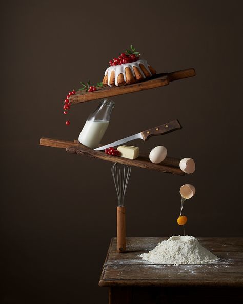 a wooden table topped with a cake and a whisk