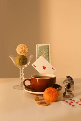 a cup of coffee and some cards on a table