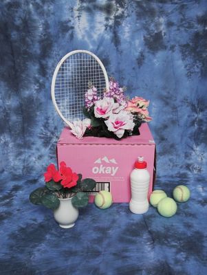 a pink box with flowers and a tennis racket