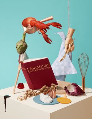 a table topped with a book and a whisk