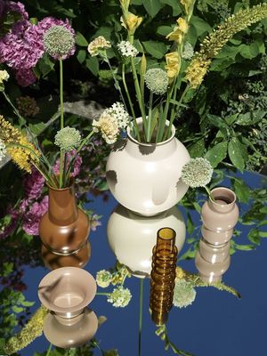 a table topped with vases filled with flowers