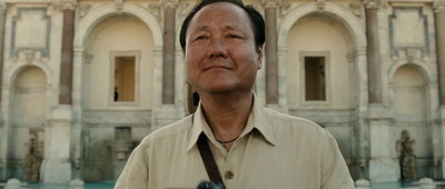 a man holding a camera in front of a building