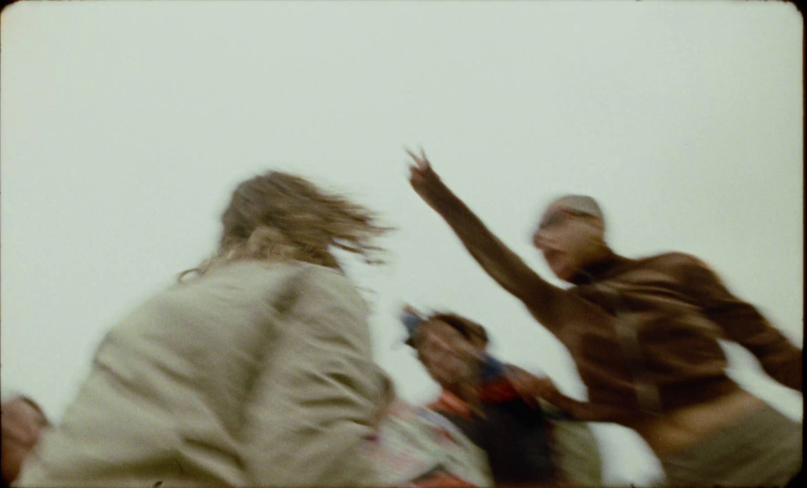 a blurry photo of a person jumping in the air with a frisbee