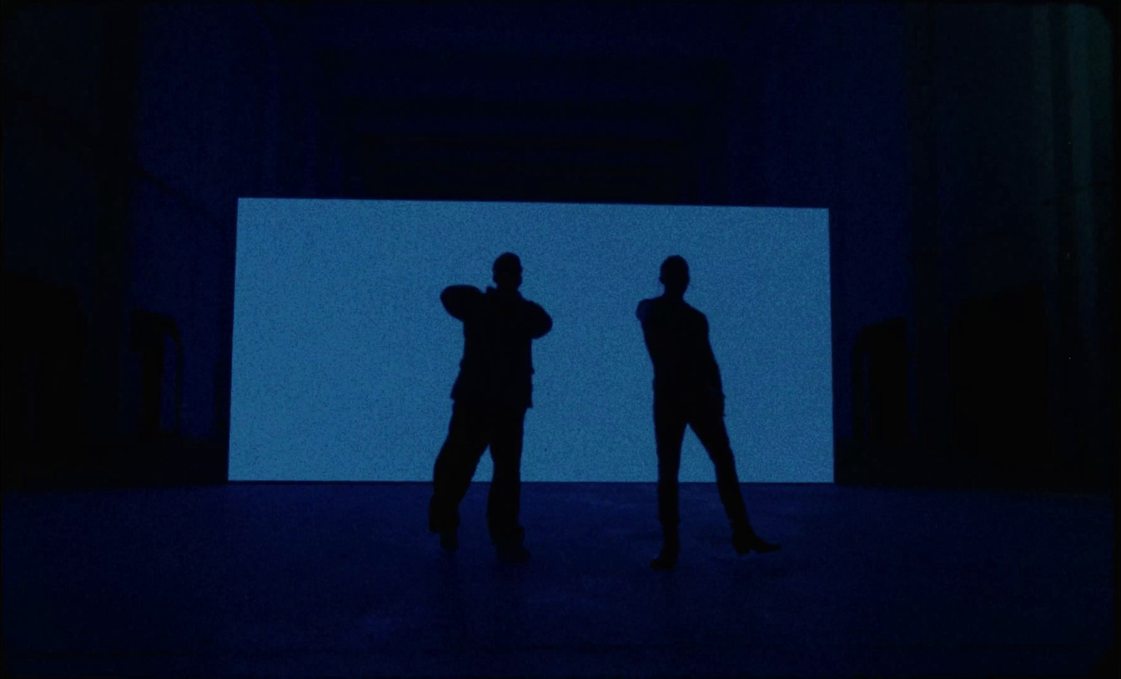 a couple of people standing in front of a blue screen