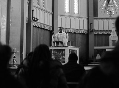 a man standing at a podium in front of a crowd