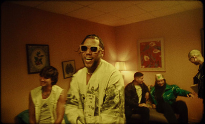 a group of men sitting around a living room together