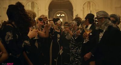 a group of people standing around each other holding wine glasses