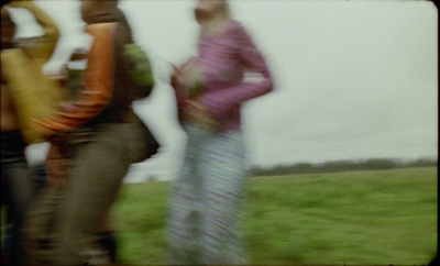 a blurry photo of a group of people standing in a field