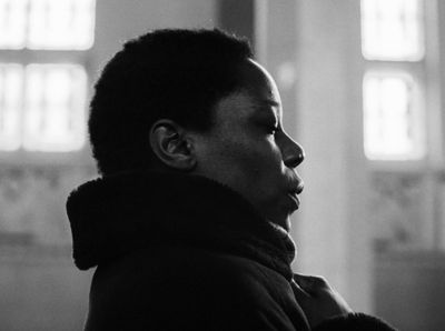 a black and white photo of a woman in a coat