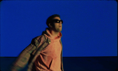 a man wearing sunglasses and a pink shirt