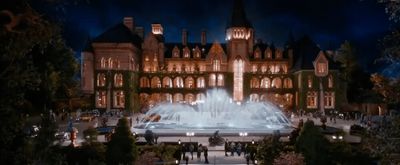 a large building with a fountain in front of it