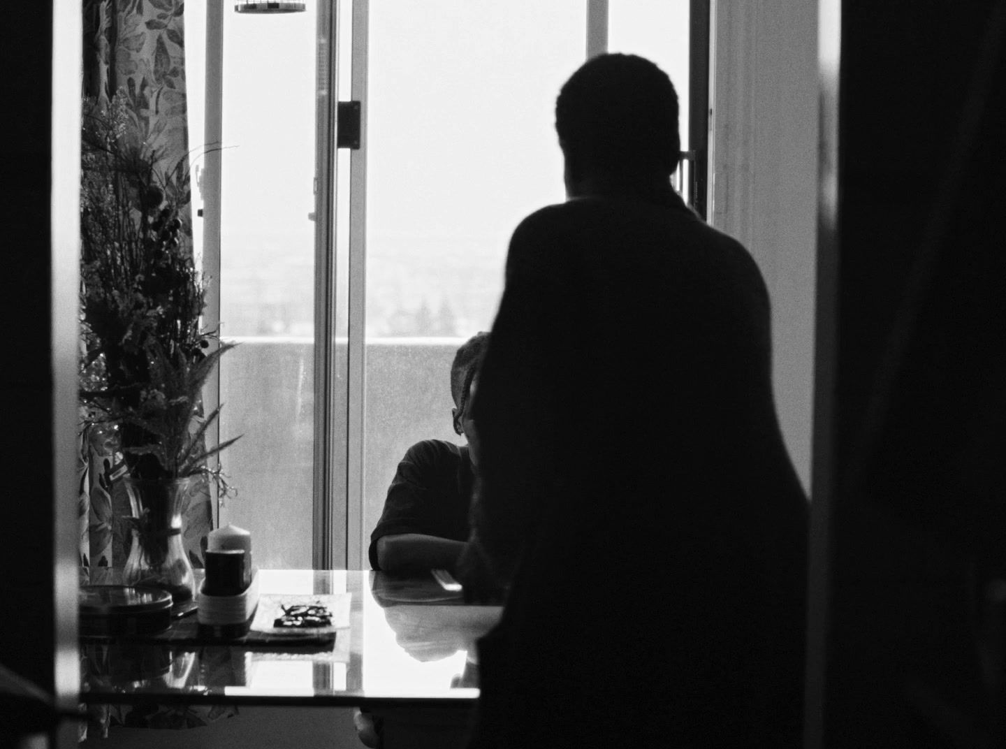 a woman standing in a kitchen next to a window