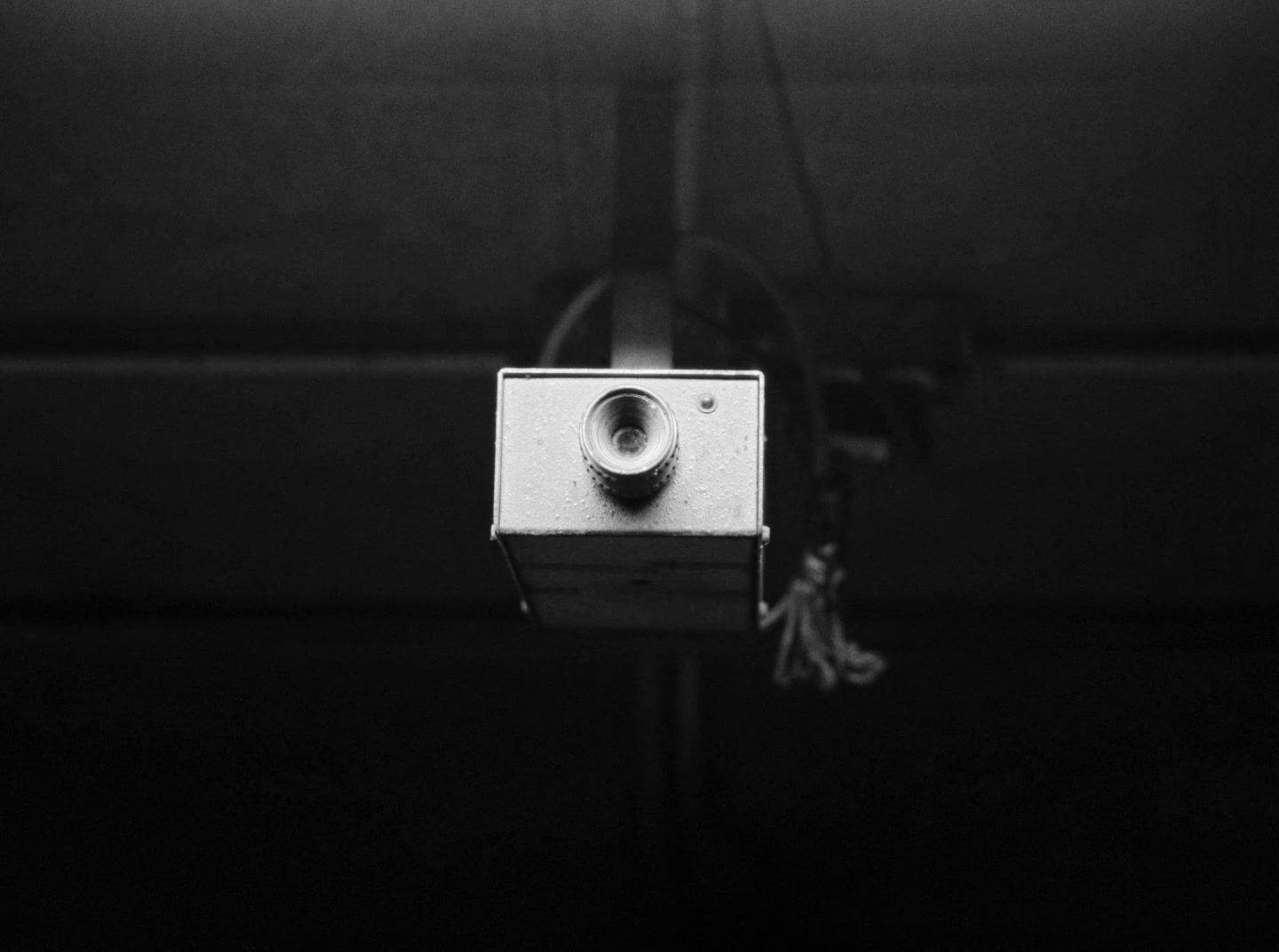 a black and white photo of a security camera