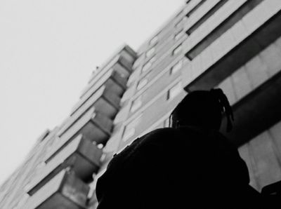 a person standing in front of a tall building