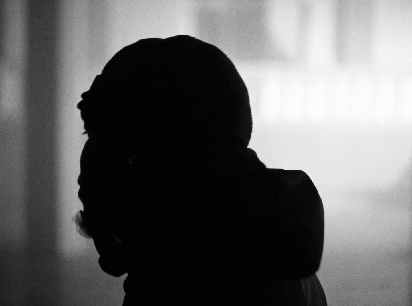 a silhouette of a person standing in a room