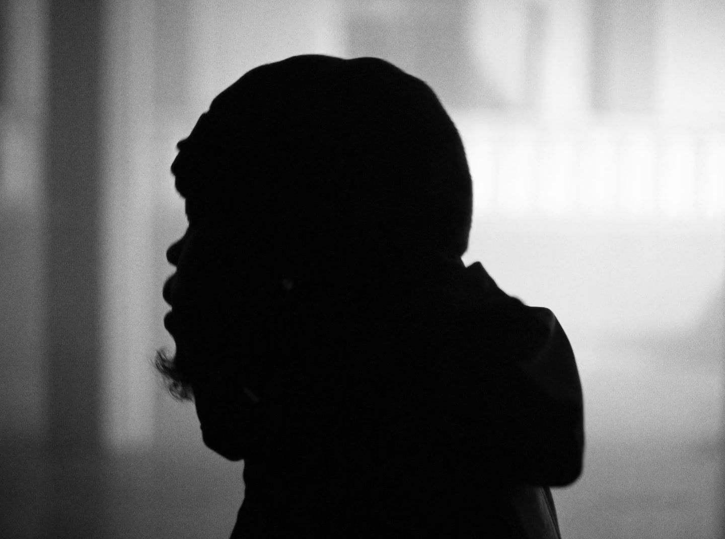 a silhouette of a person standing in a room