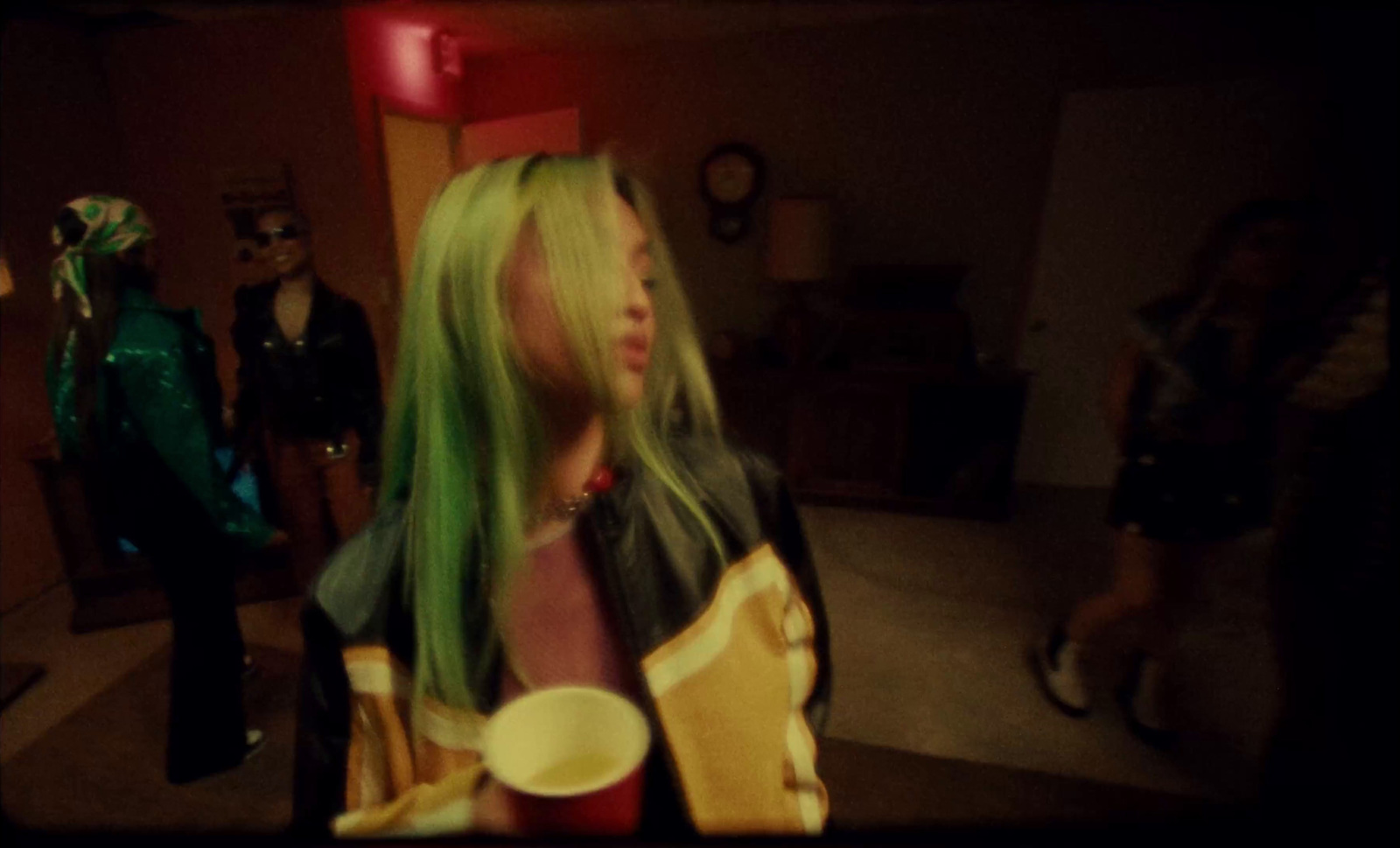 a woman with green hair is standing in a room