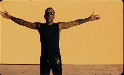 a man with his arms outstretched in front of a wall