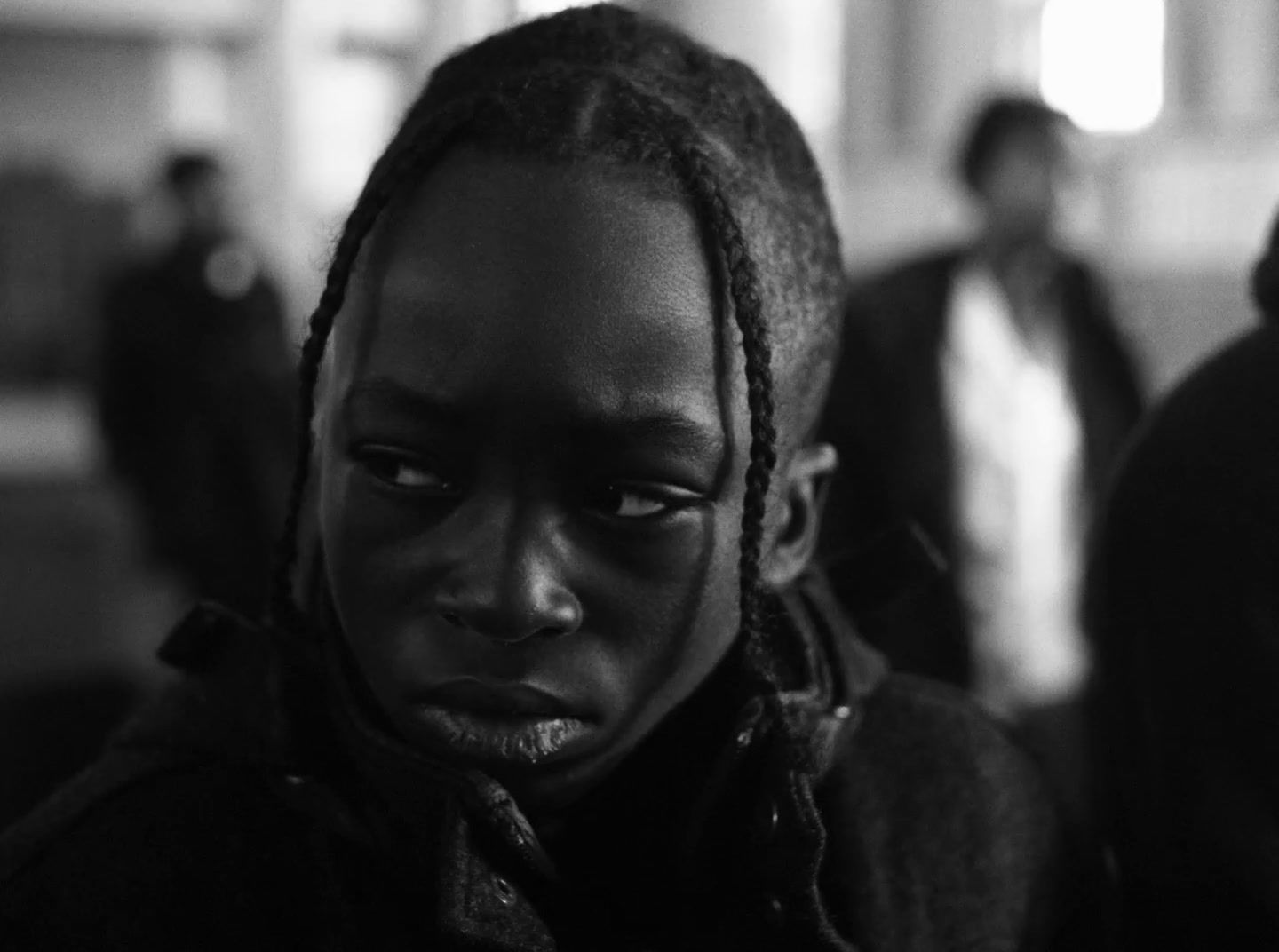 a black and white photo of a person with dreadlocks