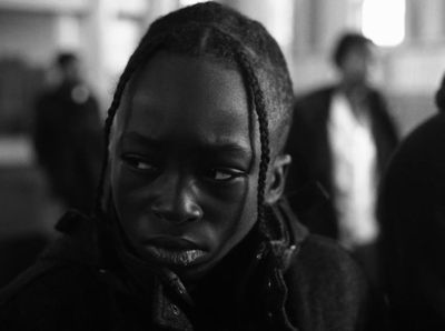 a black and white photo of a person with dreadlocks