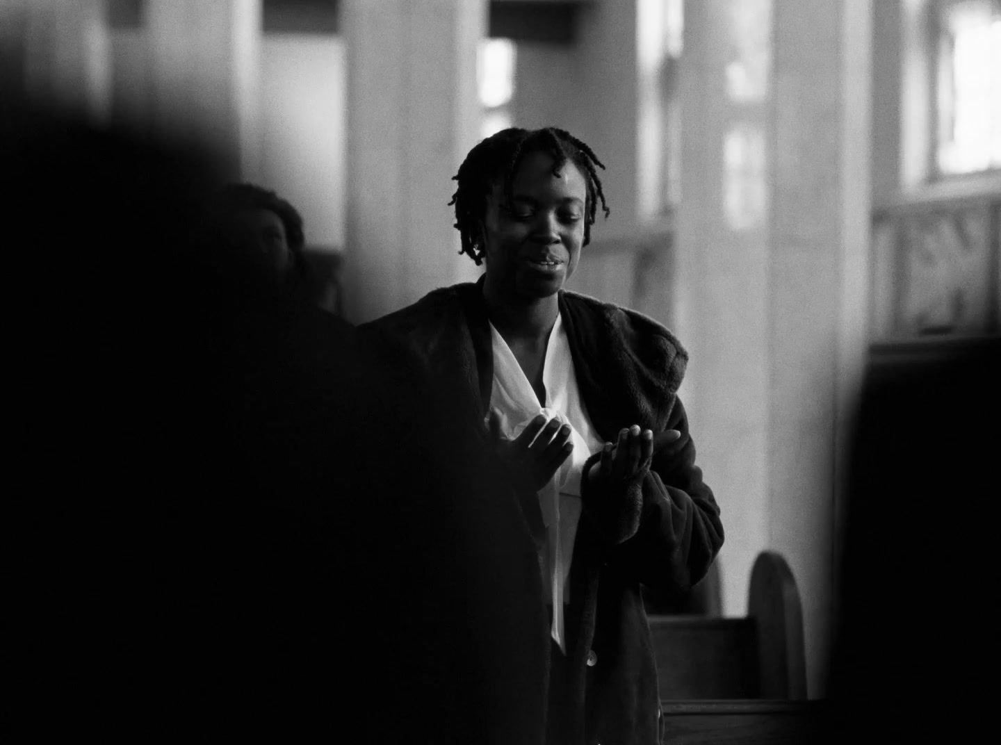 a black and white photo of a man looking at his cell phone