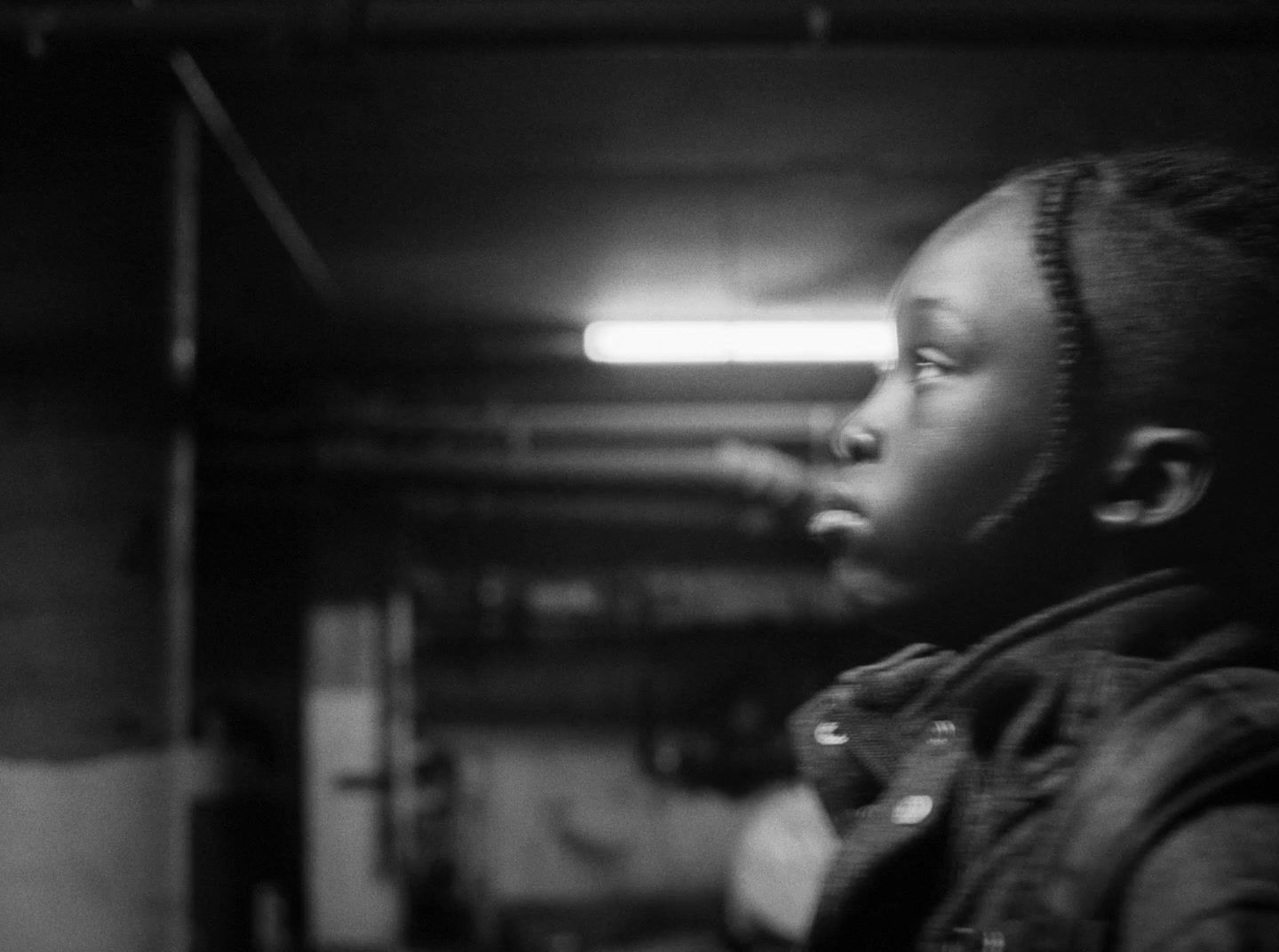 a young girl standing in a parking garage