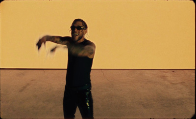 a man in black shirt throwing a white frisbee