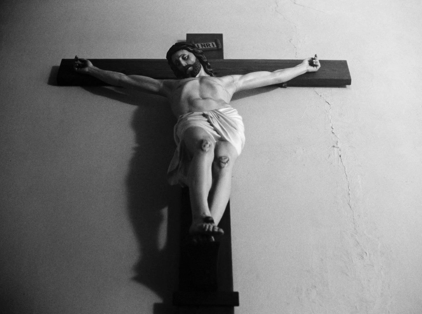 a black and white photo of a man on a cross