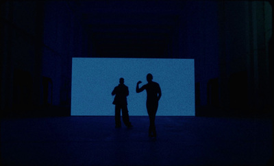 a couple of people standing in a dark room