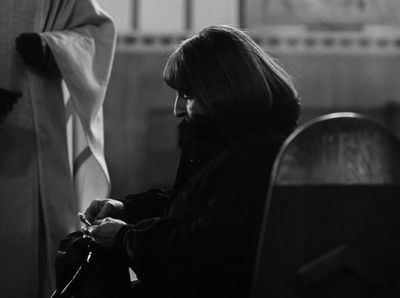 a black and white photo of a man sitting in a chair