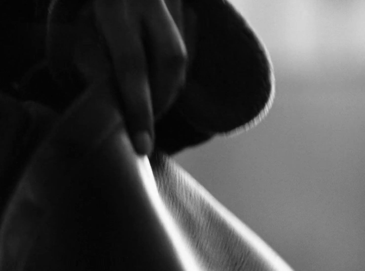 a black and white photo of a person's hand holding something