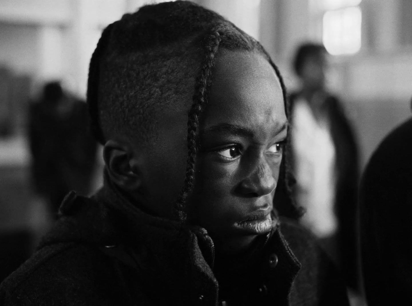 a black and white photo of a woman with dreadlocks