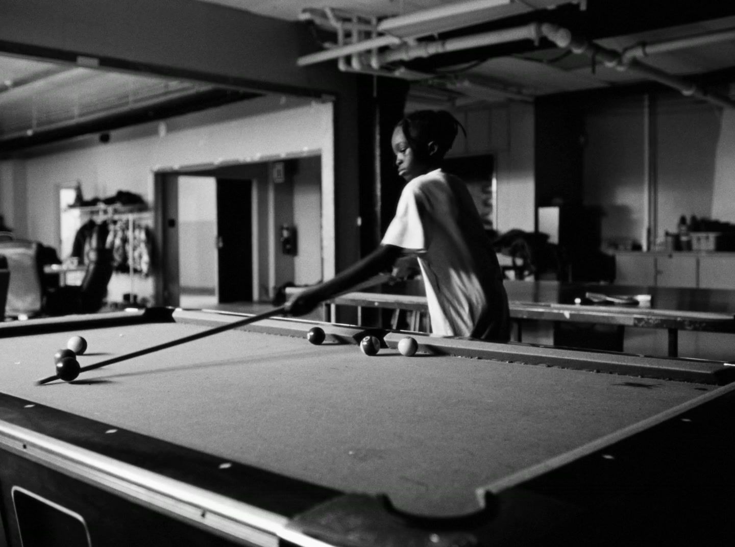 a man playing pool in a large room