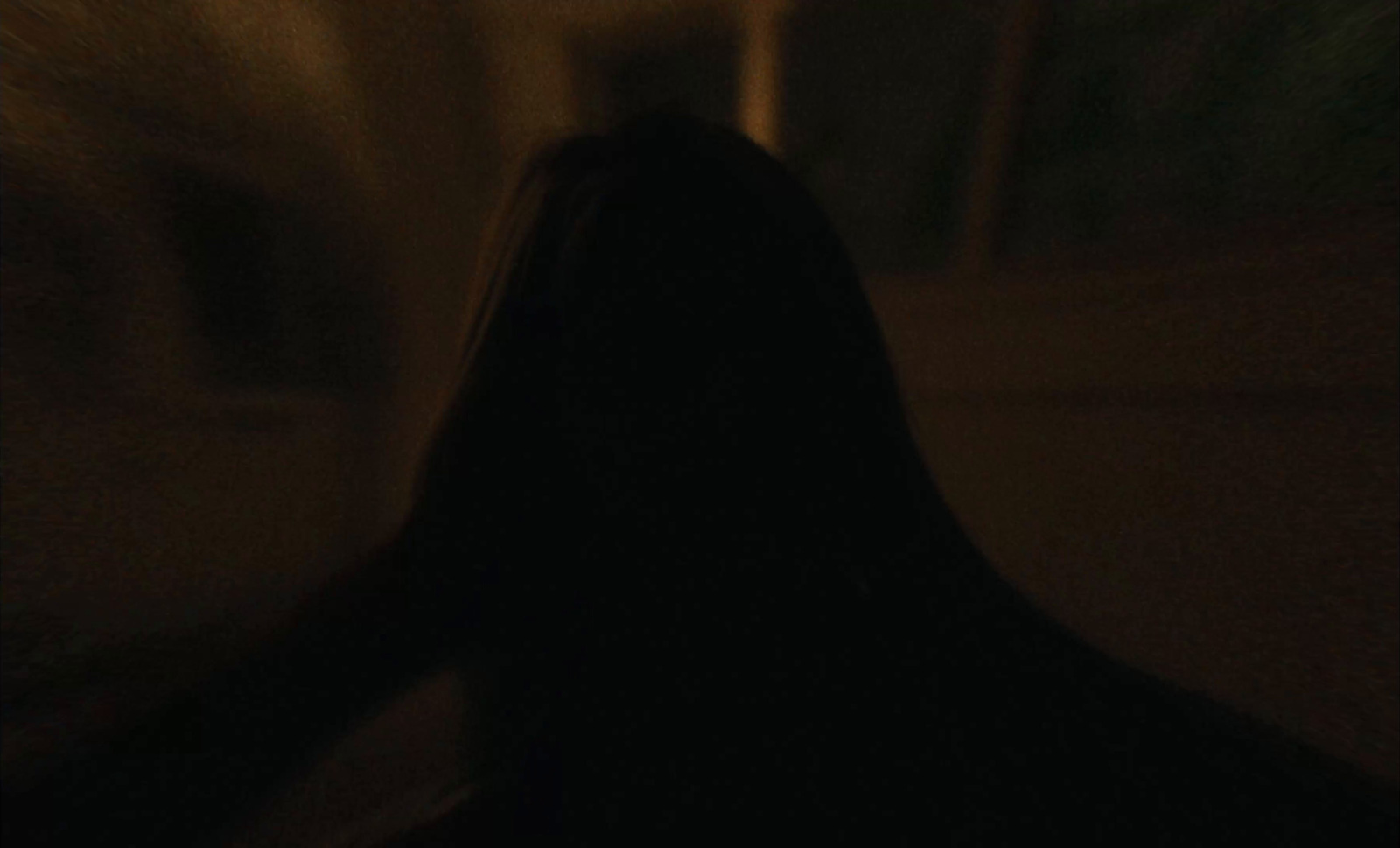 a blurry photo of a person's head in the dark