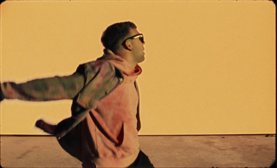 a man in a pink jacket is skateboarding