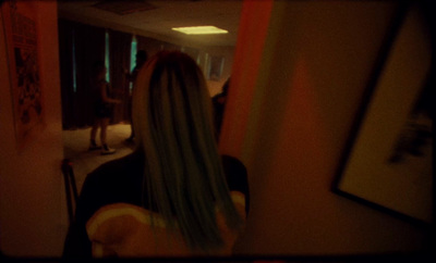 a woman with long hair standing in a room