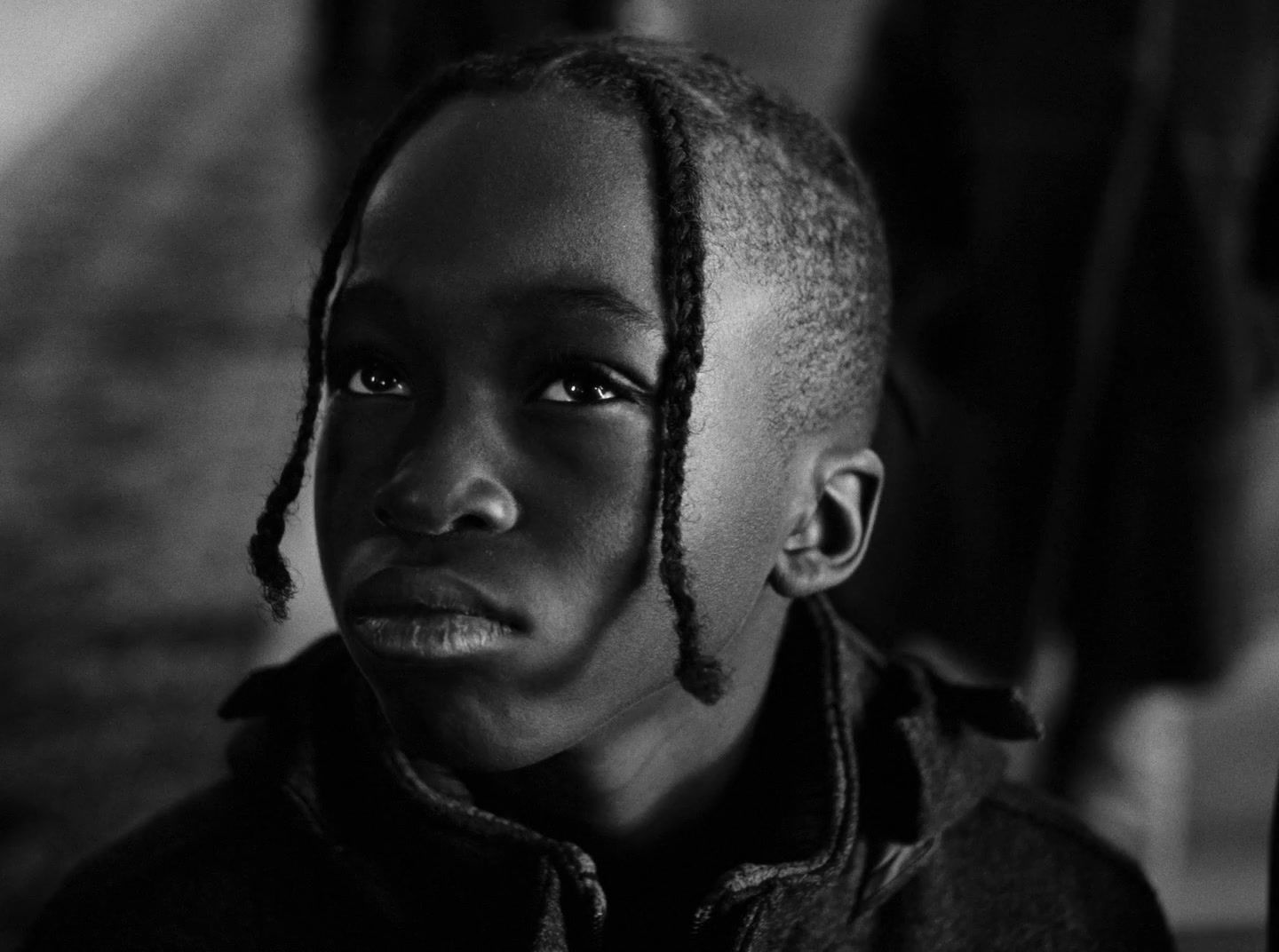 a young woman with dreadlocks on her head