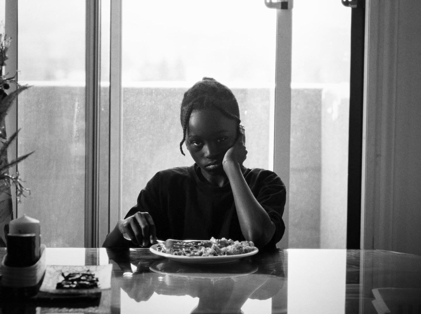 a woman sitting at a table with a plate of food