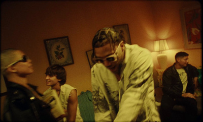 a group of young men standing around a living room