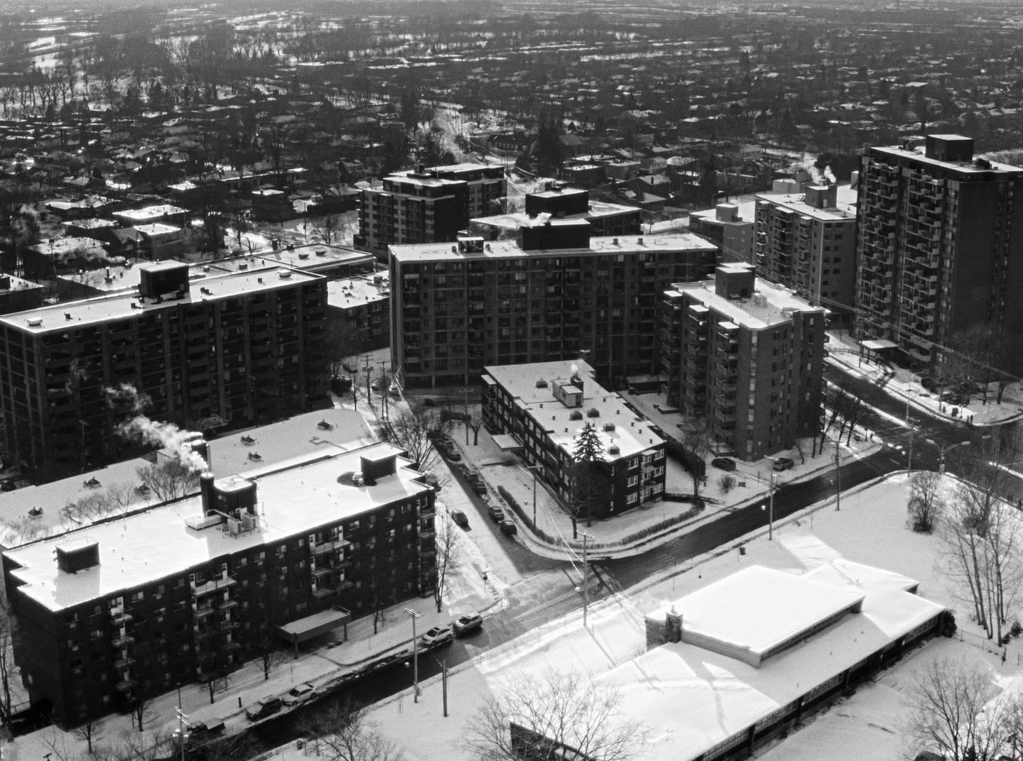 a black and white photo of a snow covered city