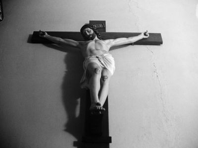 a black and white photo of a man on a cross