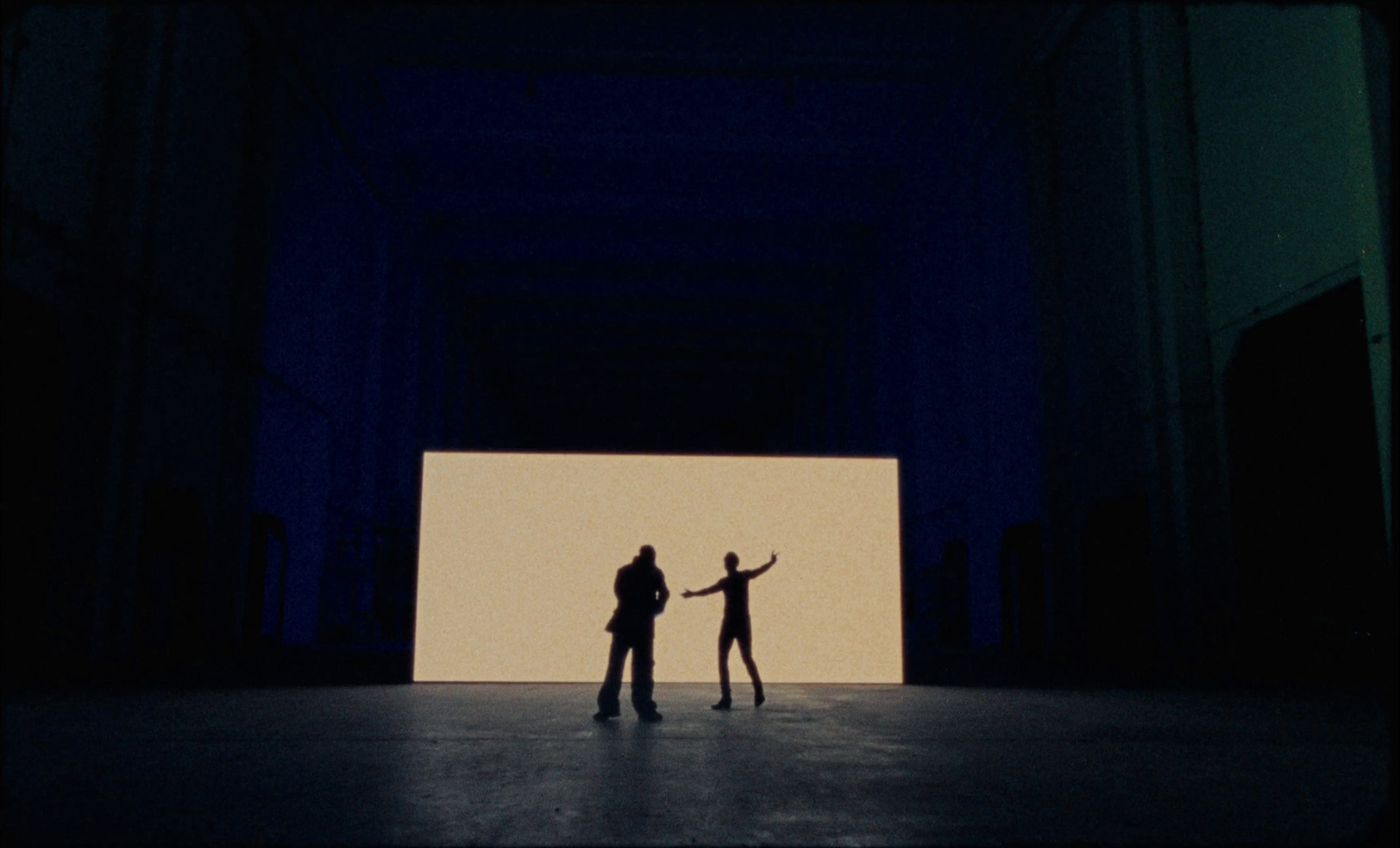 a couple of people standing in front of a white screen