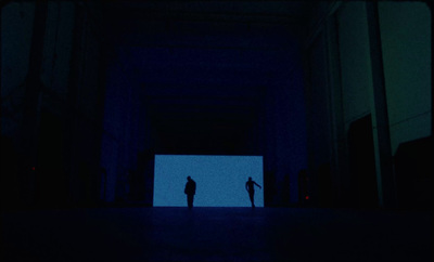 a couple of people standing in a dark room