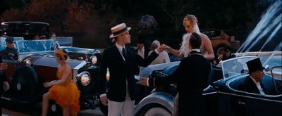 a group of people standing around a vintage car