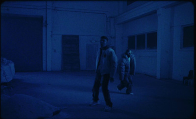 a group of men walking in a dark room