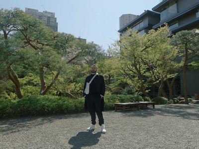 a man in a suit standing in a park