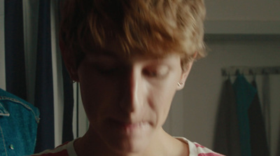 a woman with blonde hair wearing a red and white shirt