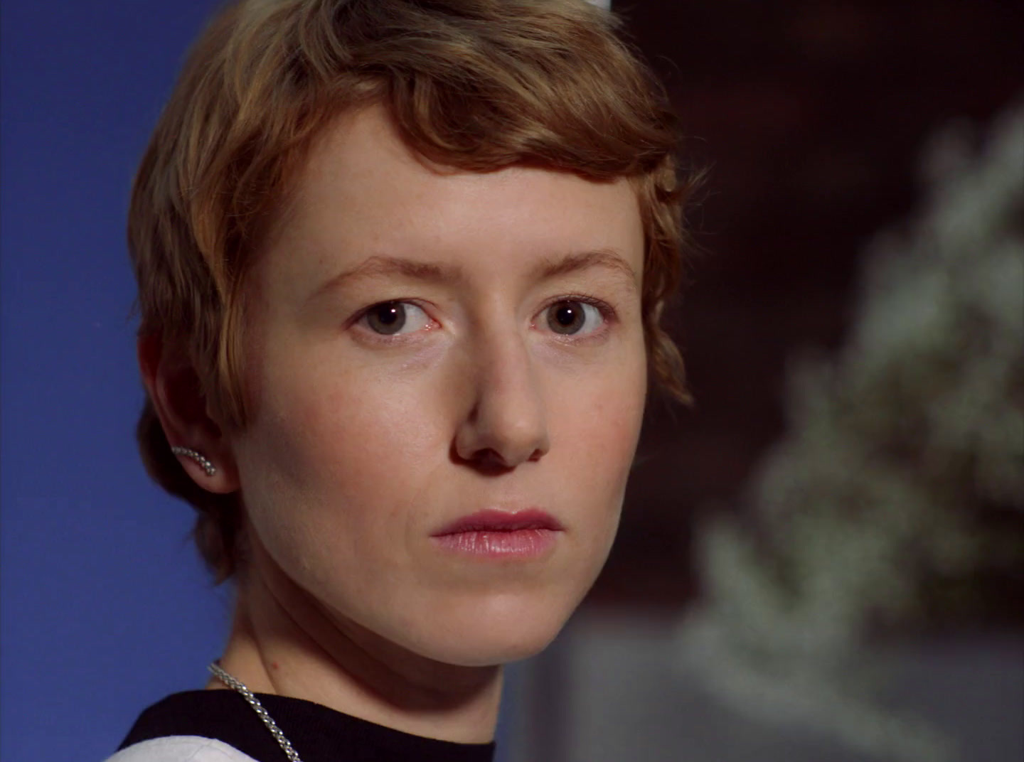 a close up of a person wearing a necklace